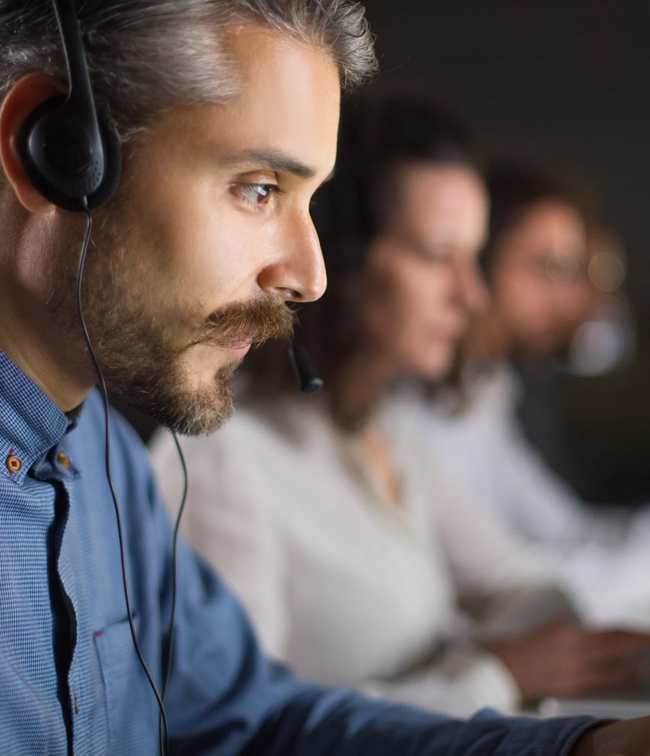 A man focusing on helping someone over the phone